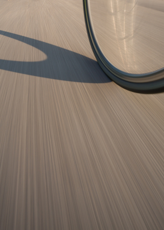 bicycle wheel on street in motionの写真素材