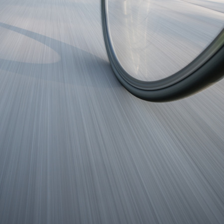 bicycle wheel on street in motionの写真素材