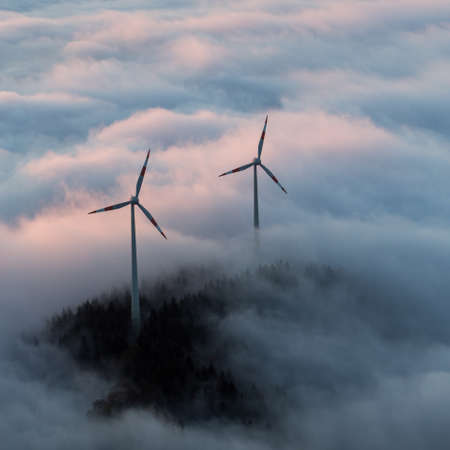wind power mills in fogの写真素材