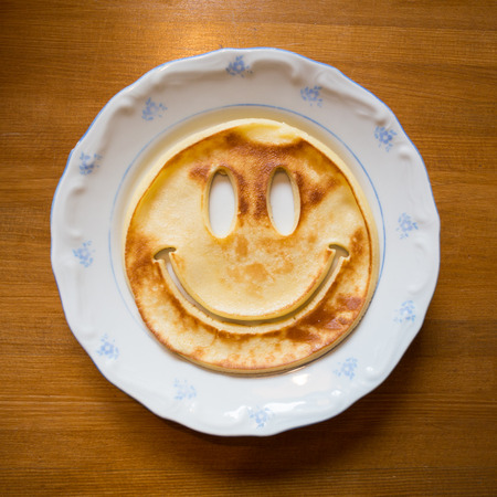 smiling pancake on plateの写真素材