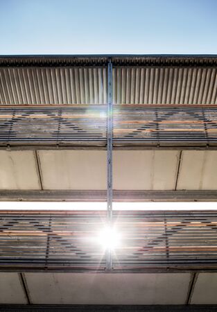 wooden footbridge with roof in skyの写真素材