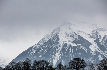 dark clouds in swiss alps in winterの写真素材