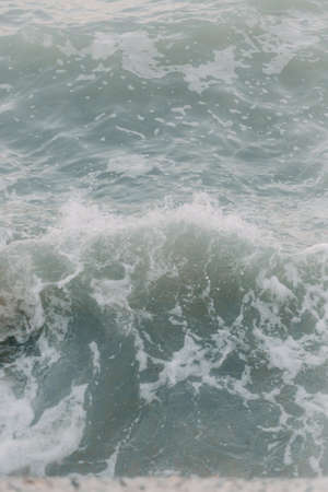 Background blue waves of the sea with sea foamの写真素材