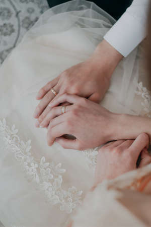 Wedding rings B W. Hands of bride and groom with rings.の写真素材