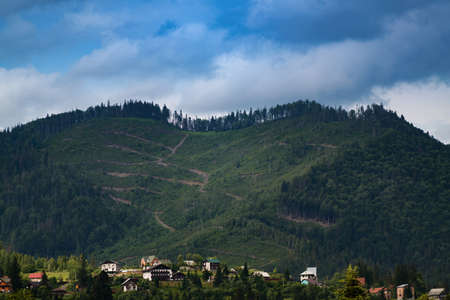 Landscape of houses with a great mountain behind themの写真素材