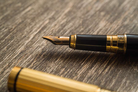 Ink pen on a wooden backgroundの写真素材