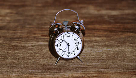 Clock on a wooden backgroundの写真素材