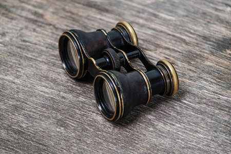 old binoculars on a wooden backgroundの写真素材
