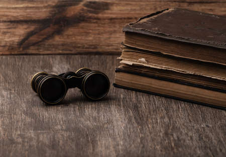 An old book of binoculars against the background of an old treeの写真素材