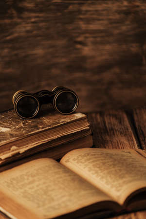 An old book of binoculars against the background of an old treeの写真素材