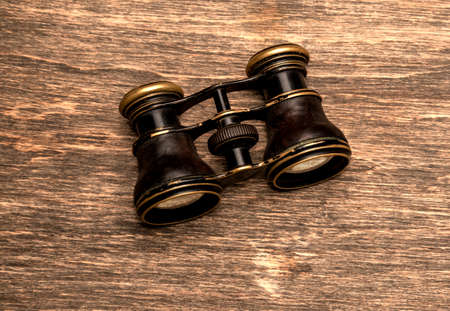 Old binoculars on a wooden backgroundの写真素材