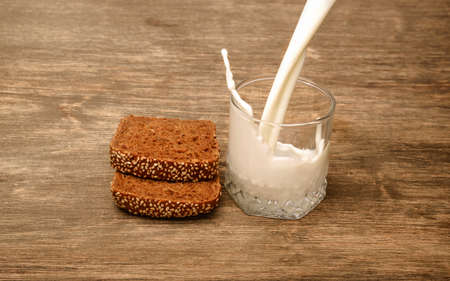 Delicious black bread milk on a wooden backgroundの写真素材