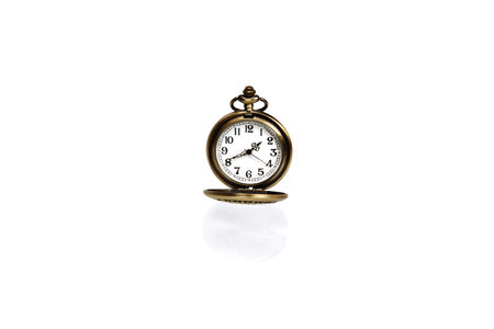 A vintage pocket watch on a white background close-up. There is a way.