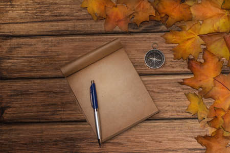 Autumn leaves on old wooden background close-up, there is a place for textの写真素材