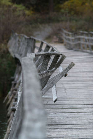 Old wooden bridge over the riverbedの写真素材