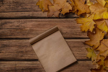 Autumn leaves on old wooden background close-up, there is a place for textの写真素材