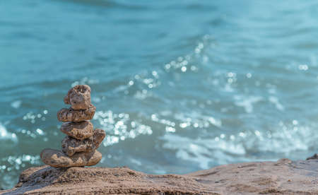 Zen concept. Object made of stone on the beach. Stone pyramid for meditation. Harmony and Meditation. Zen stones.の写真素材