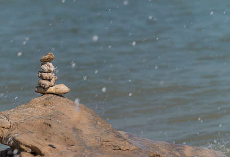 Zen concept. Object made of stone on the beach. Stone pyramid for meditation. Harmony and Meditation. Zen stones.の写真素材