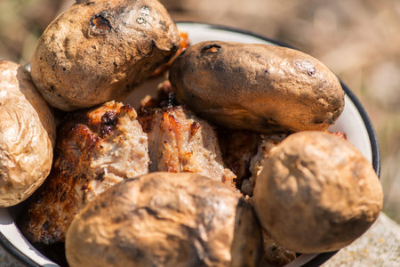 perfectly cooked barbecue potatoes and steakの写真素材