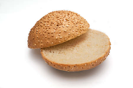 Fresh fragrant bun for burgers with sesame seeds on a white background. Can be used for advertisingの写真素材