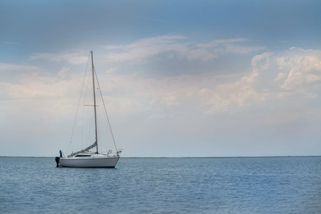 yacht at sea against a stormy skyの写真素材