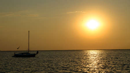 Yacht in the rays of the setting sun.の写真素材