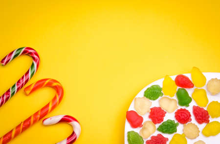 abundance of candies and fruit jelly / abundance of candies and fruit jelly on a yellow backgroundの写真素材
