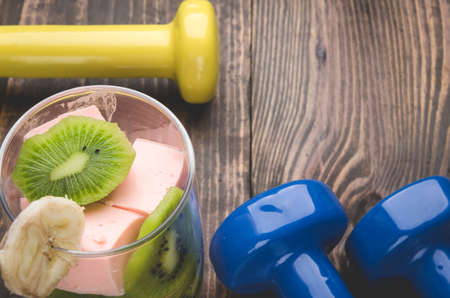 Top view of fitness concept with dumbbells and smoothieの写真素材