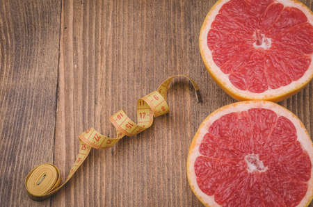 fitness background with centimeter and grapefruit ,fitness concept with centimeter and grapefruit. Top viewの写真素材