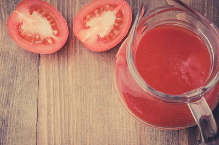 cut tomato and jug of juice / cut tomato and jug of juice the top viewの写真素材