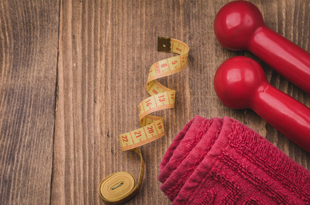 fitness background with towel, centimeter and dumbbells / fitness concept with towel, centimeter and dumbbells. Top viewの写真素材
