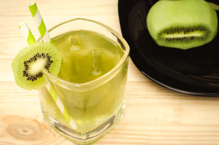 cocktail with ice and a kiwi top view / preparation of cocktail with a kiwi top viewの写真素材