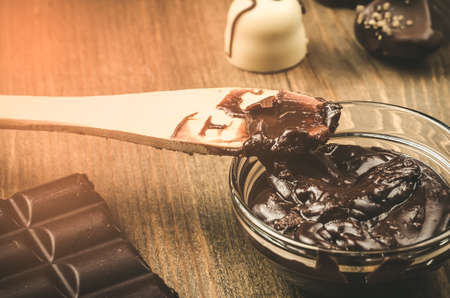 Abundance of chocolate on a wooden background. Tonedの写真素材
