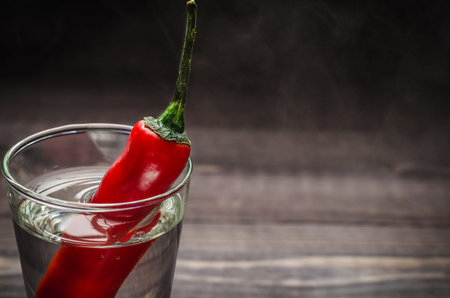 Alcohol with pepper on a background of smoke