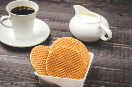 Breakfast with waffle and coffeebreakfast background with waffle and coffeebackground with waffle and coffee / cup of hot coffee and open book on a tableの写真素材