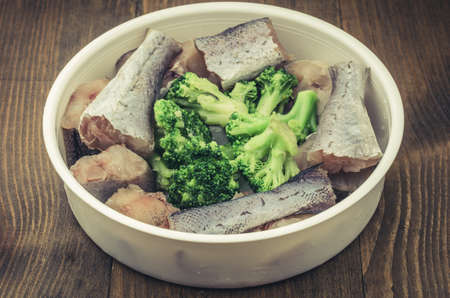 Cooking of fish with broccoli top viewの写真素材