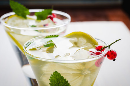 two cocktails with mint and ice on a white wooden background. Close upの写真素材