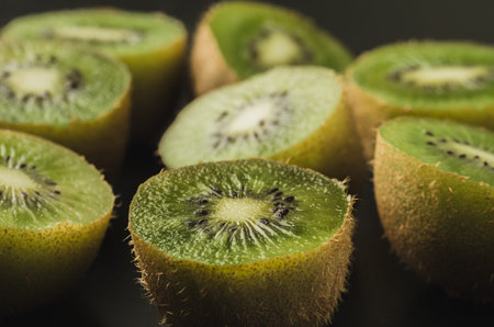 a lot of cut fresh kiwis on a wooden background/a lot of cut fresh kiwis on a wooden background. selective focusの写真素材