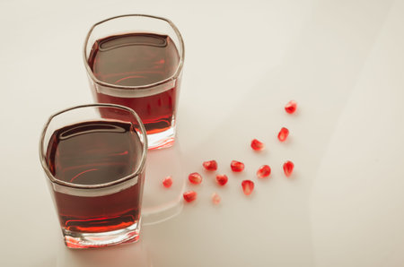 glasses of garnet juice and grain/glasses of garnet juice and grain on a white background. Top viewの写真素材