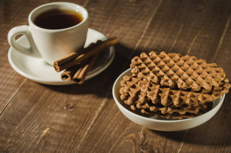 chocolate wafers and cup of coffee with cinnamon sticks/chocolate wafers and cup of coffee with...