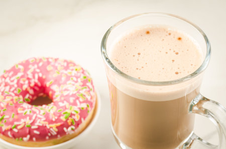 Coffee break with fresh sugary pink donut/Coffee break with fresh sugary pink donut over white...