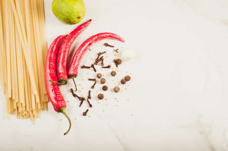 Ingredients for cooking spaghetti on a white marble background/Ingredients for cooking spaghetti on a white marble background. Top view. Copy space

の写真素材