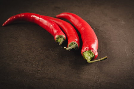 red hot Chile pepper on a dark background/red hot Chile pepper on a dark stone background. Selective...