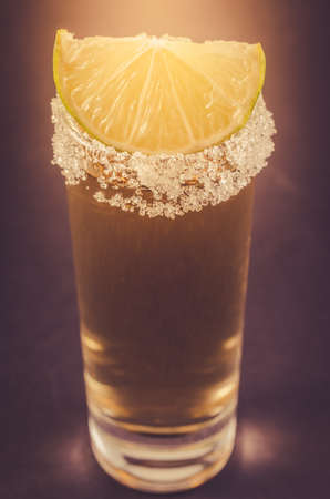 Tequila shot with lime fruit/Tequila shot with lime fruit. Cloes up and tonedの写真素材