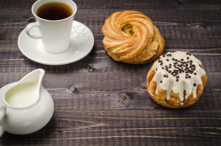 coffee with cake and milk/breakfast: coffee with cake and milk on a dark wooden background. Copy spaceの写真素材