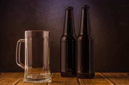 empty beer glass and two bottles/empty beer glass and two bottles on a barの写真素材