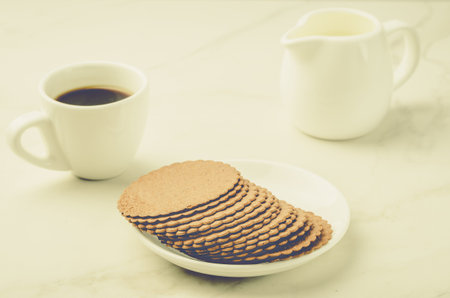 espresso white cup with cookies and milk/espresso white cup with cookies and milk on white table. 