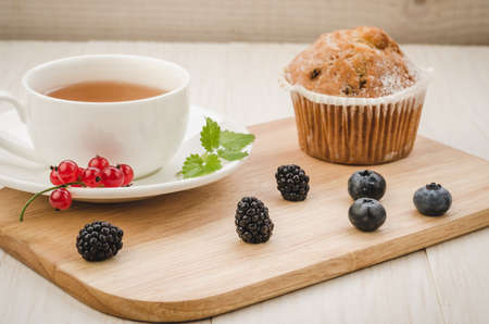 healthy breakfast: tea with mint, cake and fresh berries/healthy breakfast: tea with mint,  cake and fresh berries on a wooden surface. Selective focusの写真素材