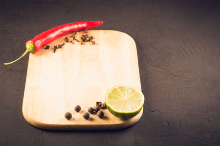 spices and empty cutting board on a dark background. selective focusの写真素材