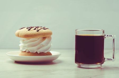 Espresso glass and dessert on white marble background. Selective focus